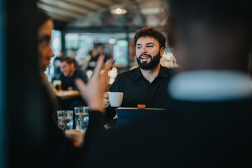 A business professional engages in a brainstorming session with colleagues in an informal setting,...