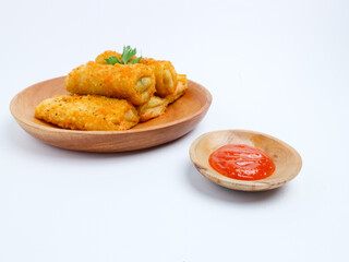 Crispy Indonesian risol mayo rolls served on a wooden plate with chili sauce in a small bowl, isolated on a white background