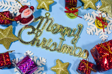 Elegant Christmas background with blue and gold decorations, including baubles, stars, and wrapped...