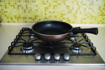 Empty Non-Stick Frying Pan on Gas Stove in Modern Kitchen