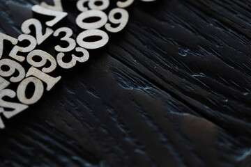 Abstract Wooden Numbers on Dark Textured Surface - Close-Up Detail