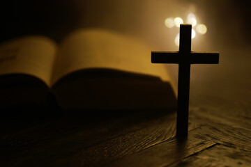 Silhouette of Cross with Open Bible Background in Soft Light for Faith and Spirituality Concepts
