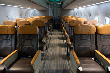 Background and banner : Empty passenger seats. empty comfortable business class seats. Inside modern private jet airplane