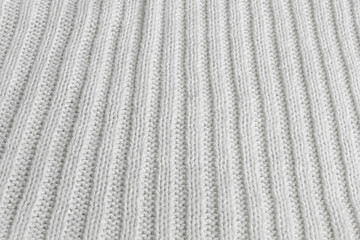 Soft white knitted fabric showcasing intricate ribbing patterns for cozy textiles