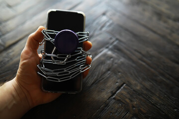 Smartphone Security with Chain and Padlock on Wooden Surface
