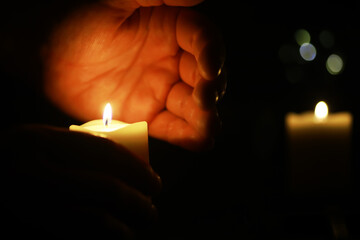 Hands Holding Candle in Darkness - Candlelight Vigil, Warmth, Tranquility, Serenity, Prayer