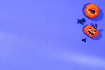 Fototapeta premium Vibrant Halloween decoration with orange and purple background. Perfect for party designs, invitations, or themed content.