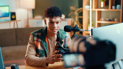 Man, influencer and online streaming with video camera for gaming tips, tutorial or live recording....