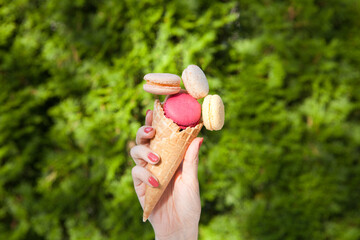 sweet meringue. Bright food photography of macroons on womans hand. French macaroon