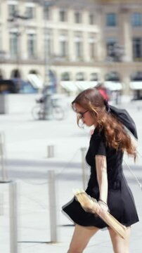 Brisk walk with baguette at Place Vendome in Paris