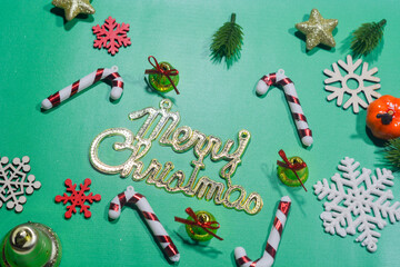 Elegant Christmas background with pink and gold decorations, including baubles, stars, and wrapped...