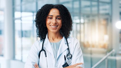 Doctor, woman and smile with arms crossed in portrait, hallway and pride for healthcare services at...
