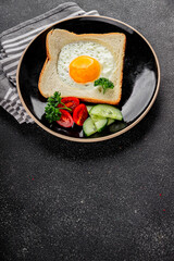 Fried gashouse eggs in bread egg in the basket delicious snack breakfast in a bowl fresh delicious gourmet food background on the table rustic food top view copy space
