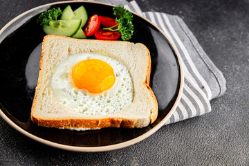 Fried gashouse eggs in bread egg in the basket delicious snack breakfast in a bowl fresh delicious gourmet food background on the table rustic food top view copy space