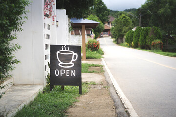 Coffee shop open sign on the roadside
