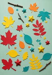 Colorful autumn paper cutouts arranged on a light green background