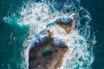 Powerful surf breaks on beautiful rocks and stones. View from above