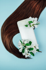 Shampoo, hair conditioner in a white jar on a blue background. Mockup, space for text. White...