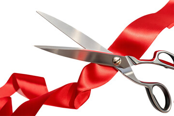 A close up shot of silver scissors cutting through a bright red ribbon against a black background space