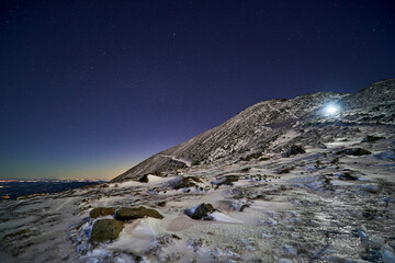 Winter night hike in snowy mountains, amazing landscape. Active hobby concept