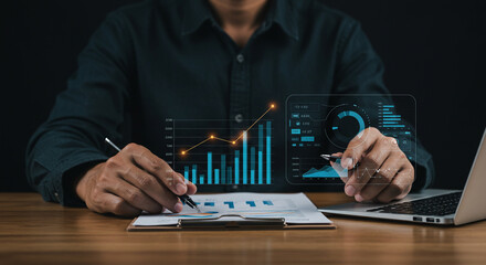 Business professional analyzing digital data visualizations on laptop in office setting