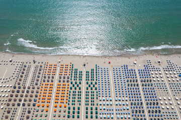 Viareggio colorful umbrellas on the seashore seen from above on a summer day