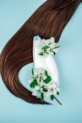 Shampoo, hair conditioner in a white jar on a blue background. Mockup, space for text. White...