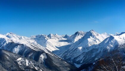 snowy mountain range under a clear sky