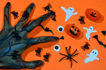 Background with a Halloween theme, with scary ghost finger objects, lollipops and scary pumkins. October is the month of ghosts