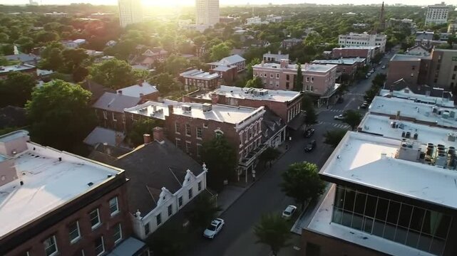 Drone glides over a historic district, revealing older buildings nestled between newer ones