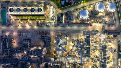 Aerial top view petrochemical plant oil refinery storage tank pipe line at night, Petroleum oil...