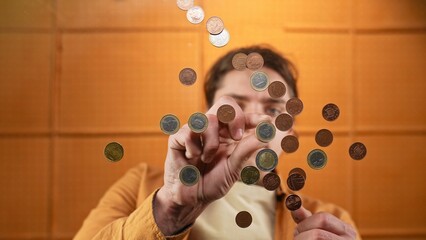 Man Interacting with Coins Below the Glass Table Captured in Photo