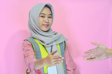 Young Asian woman an attractive young female construction worker working. Carrying a map,...