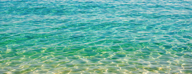 Ripple water of ocean. Aquamarine ocean nature. Background of clear turquoise sea water. Idyllic...