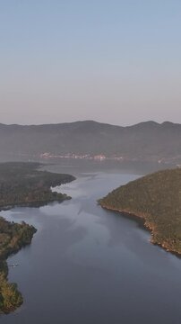Florianopolis in Santa Catarina during a wonderful sunrise. Mo&ccedil;ambique Beach in aerial view, vertical video.