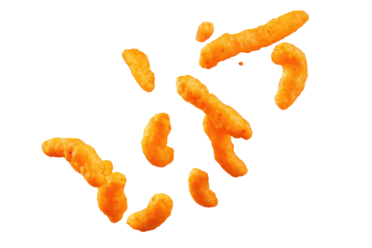 A scattered arrangement of cheese puffs against a stark black backdrop creating a simple composition