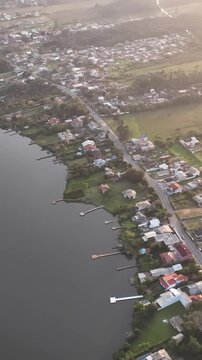 Florianopolis in Santa Catarina during a wonderful sunrise. Mo&ccedil;ambique Beach in aerial view, vertical video.