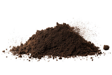 A mound of dark brown soil or dirt is piled up against a black background in a studio setting shot