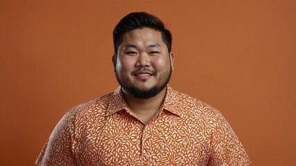Obraz premium Plus size Asian man plain orange background, looking proud