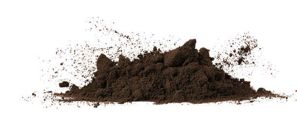 A pile of dark brown soil or dirt against a black background with some dust particles in the air around it