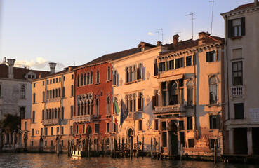Venetian architecture and scenic canal views captured in Venice, Italy. Iconic landmarks, gondolas, historic facades, and peaceful waterways under clear blue skies. Perfect visuals for travel, culture