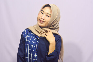 Beautiful young student girl wearing green student t-shirt smiling happily pointing with hand and finger to the side on isolated purple background