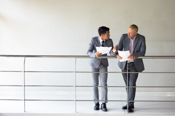 Business meeting : Business colleagues talking in the office. Group of business man talking in modern office building