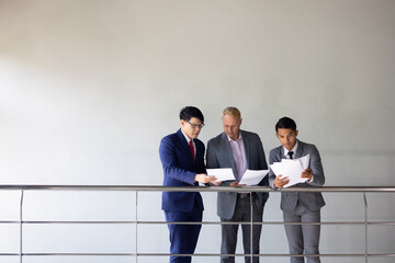 Business meeting : Business colleagues talking in the office. Group of business man talking in modern office building