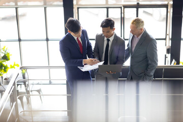 Business meeting : Business colleagues talking in the office. Group of business man talking in modern office building