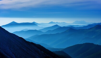 Fototapeta premium blue haze over a mountain range adding a mystical and ethereal atmosphere to the landscape