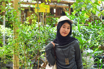 Young Indonesian woman smiling happily. enjoy time in the park