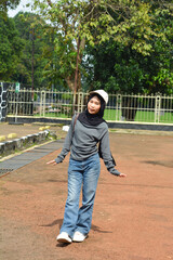 Young Indonesian woman smiling happily. enjoy time in the park