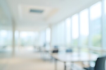 blurry image of office interior with bright, modern desk chairs and large windows