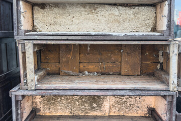 Old wooden shelves are stacked on the street. Close-up, selective focus.